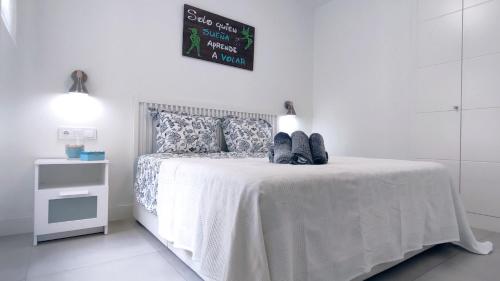 a white bedroom with a bed with a white bedspread at Panorama Beach - Blue Horizon in Torrox Costa