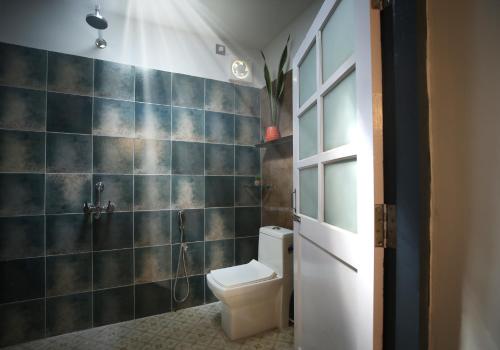 a bathroom with a toilet and a shower at Craft Hostels in Anjuna
