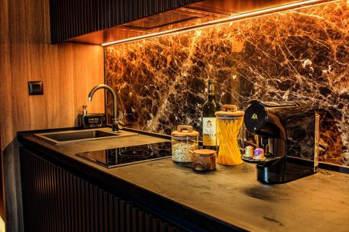 a kitchen with a sink and a counter top with a sink at Woodside Kopaonik in Kopaonik