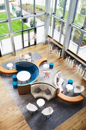 a large room with tables and chairs and windows at Hyatt Regency Manchester in Manchester