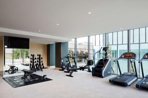 a gym with treadmills and cardio equipment in a building at Hyatt House Manchester - Aparthotel in Manchester