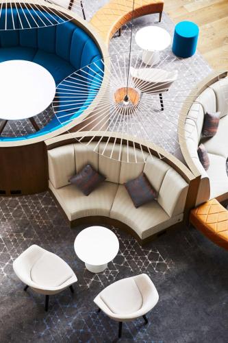 an overhead view of a lobby with a couch and tables at Hyatt House Manchester - Aparthotel in Manchester