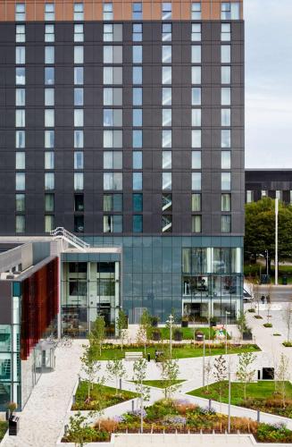 an external view of a building with a courtyard at Hyatt House Manchester - Aparthotel in Manchester