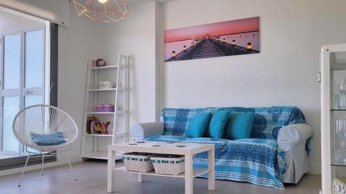a living room with a couch and a table at Panorama Beach - Blue Horizon in Torrox Costa