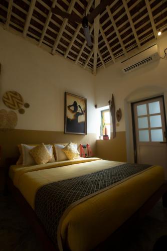 a bedroom with a large bed in a room at Craft Hostels in Anjuna