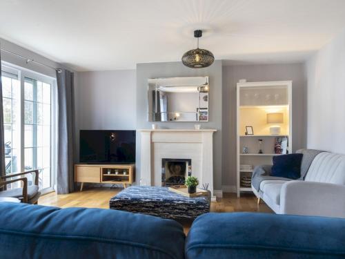 a living room with a couch and a fireplace at Gorgeous 3BR Townhouse with Garden South Belfast - Pass the Keys in Belfast