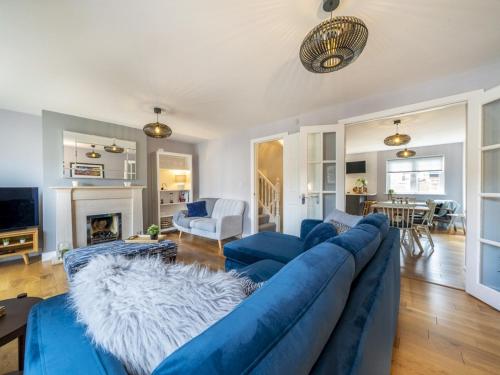 a living room with a blue couch and a fireplace at Gorgeous 3BR Townhouse with Garden South Belfast - Pass the Keys in Belfast