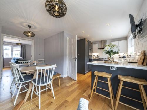 a kitchen and living room with a table and chairs at Gorgeous 3BR Townhouse with Garden South Belfast - Pass the Keys in Belfast