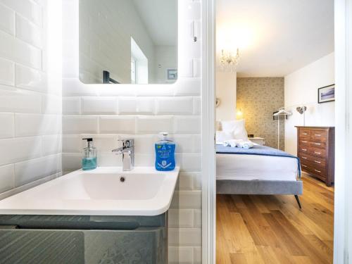 a bathroom with a sink and a bed at Gorgeous 3BR Townhouse with Garden South Belfast - Pass the Keys in Belfast
