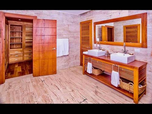 a bathroom with two sinks and a mirror at Srvittinivillas Cn-ll66 Great Villa Good Location Casa de Campo Resort Villa in La Romana