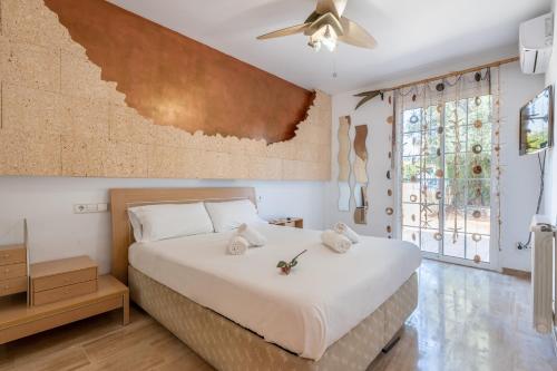a bedroom with a bed and a ceiling fan at Villa Sayana in Palma de Mallorca
