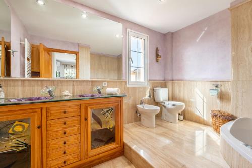 a bathroom with a toilet and a sink at Villa Sayana in Palma de Mallorca