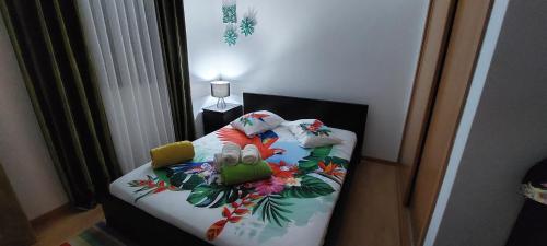 a bedroom with a bed with a flower pattern on it at Ocean View Flat in Ponta Delgada