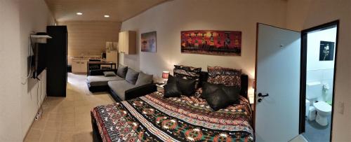 a room with a bed and a living room at Tante Emma Kapstadt in Paderborn