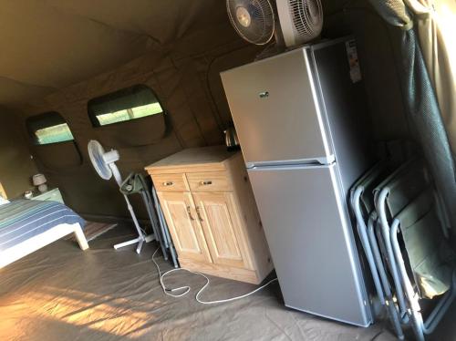 a kitchen with a refrigerator in a trailer at Kruger Ranch in Magaliesburg