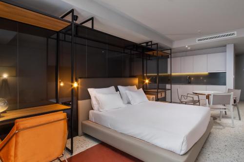 a bedroom with a large bed and a table at NEXT - by Savoy Signature in Funchal