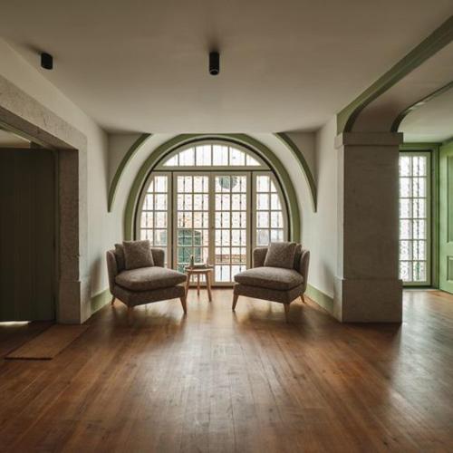 a large room with two chairs and a large window at Look Living, Lisbon Design Apartments in Lisbon