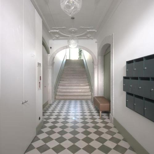 a hallway with a staircase with a checkered floor at Look Living, Lisbon Design Apartments in Lisbon