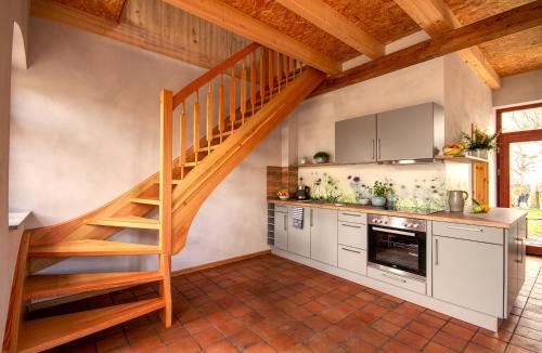 a kitchen with a wooden staircase in a house at Ferienwohnung Bolbritz in Bautzen