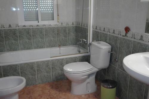 a bathroom with a toilet and a sink and a tub at Veronica Villa in Partaloa