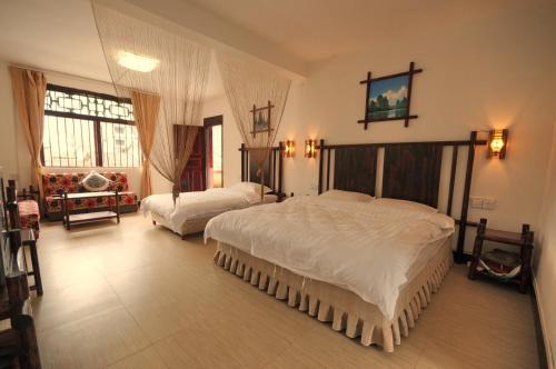 a large bedroom with two beds in it at Xingping Our Inn in Yangshuo