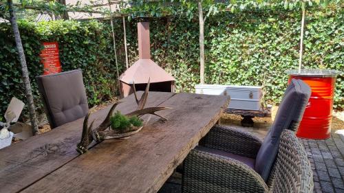a wooden table with chairs and a tableablish at AirstreamNB in Schayk