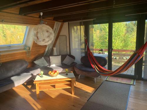 a living room with a couch and a hammock at Haus Fichtelgebirge in Nagel