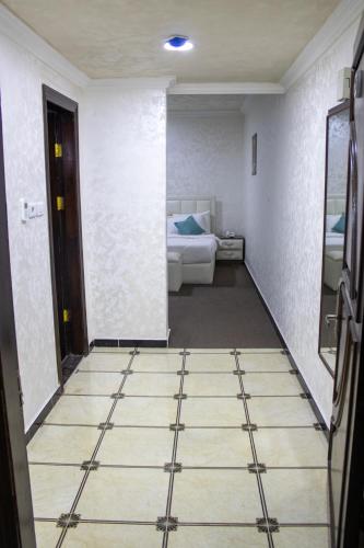 a room with a bedroom with a bed and a floor at The Castle Hotel in Amman
