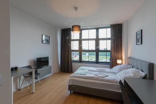 Posteľ alebo postele v izbe v ubytovaní SleepWell Apartments