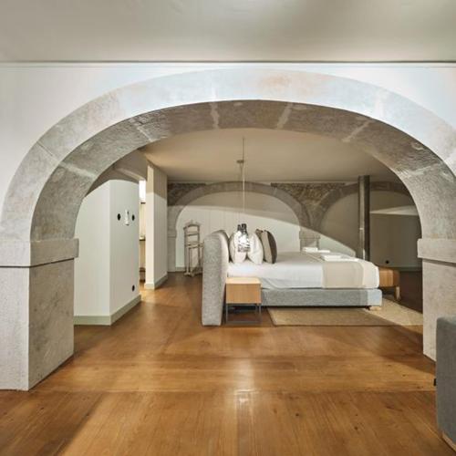 a bedroom with a large bed in an archway at Look Living, Lisbon Design Apartments in Lisbon