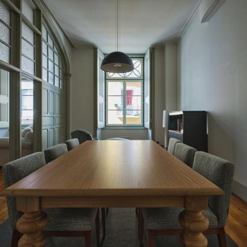 a conference room with a wooden table and chairs at Look Living, Lisbon Design Apartments in Lisbon