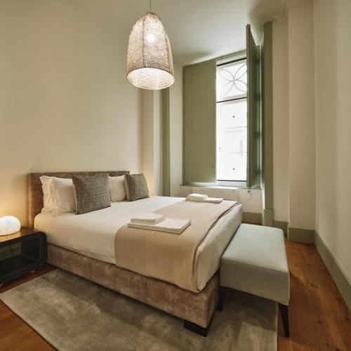 a bedroom with a large bed and a window at Look Living, Lisbon Design Apartments in Lisbon