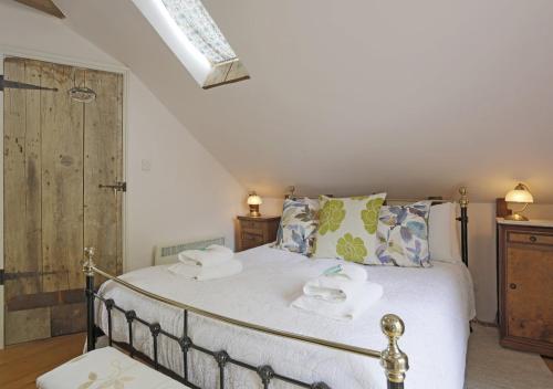 a bedroom with a bed with towels on it at The Carters Loft in Badingham