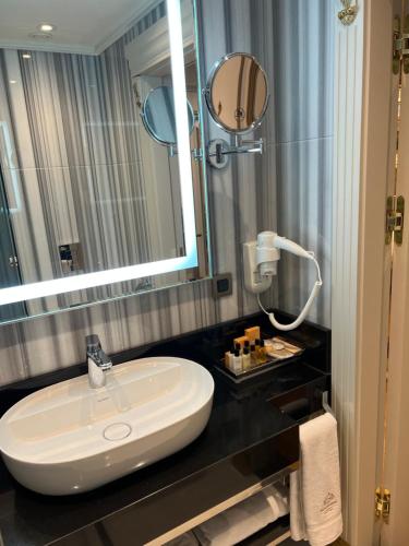 a bathroom with a sink and a mirror at MANORS HOTEL in Istanbul