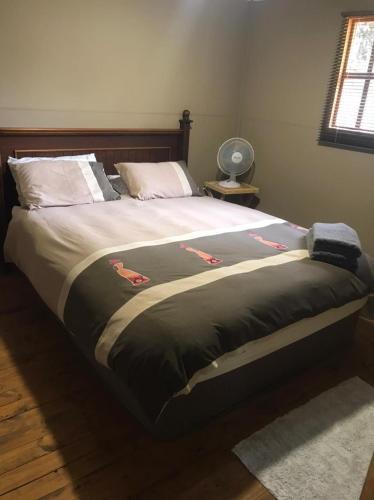 a large bed in a bedroom with at Kruger Ranch in Magaliesburg