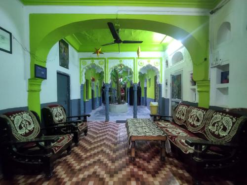 a living room with a couch and chairs in a room at Savitri Palace in Pushkar