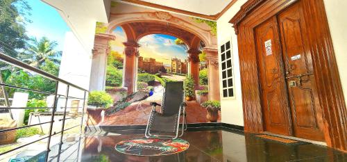 a room with a balcony with a painting on the wall at JJ's White House in Trichūr