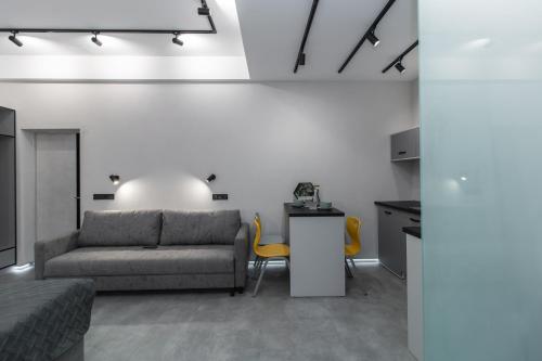 a living room with a couch and a table at Stories Hub in Lviv