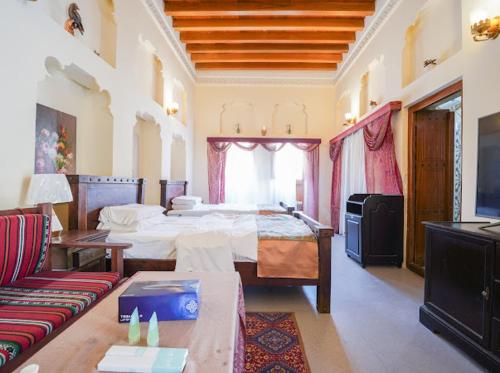 a large room with two beds and a couch at Heritage Home Guest House in Dubai