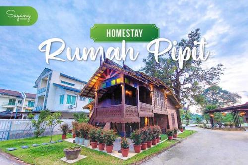 a sign that says rumpillipurpur with a building at Sayang Di Kaki Bukit Homestay Near Icon City Bukit Mertajam in Bukit Mertajam