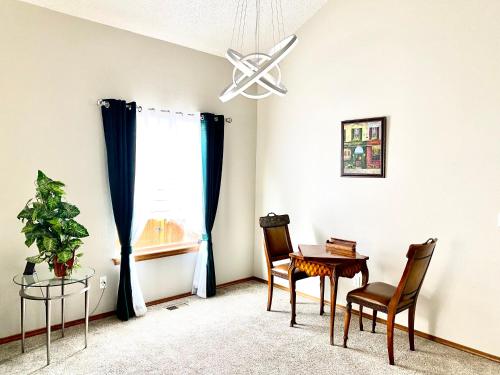 a dining room with a table and chairs and a window at Artsy Home close to USAFA with Fireplace and Patio in Colorado Springs