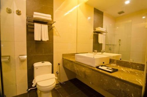 a bathroom with a sink and a toilet and a mirror at MyDream Guest House in Ipoh