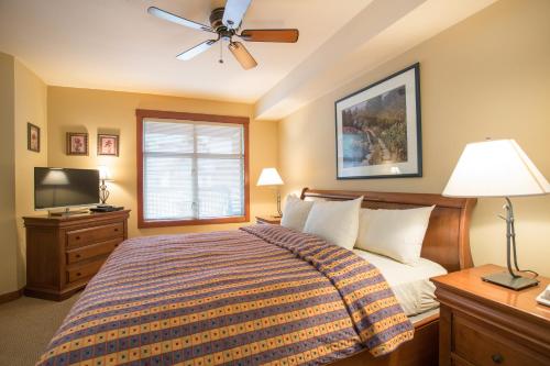 a bedroom with a bed and a ceiling fan at 3221 - Three Bedroom Standard Powderhorn Lodge condo in Solitude