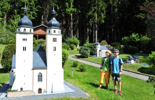 two boys standing in front of a miniature castle at Landhotel Jungbrunnen in Bad Brambach