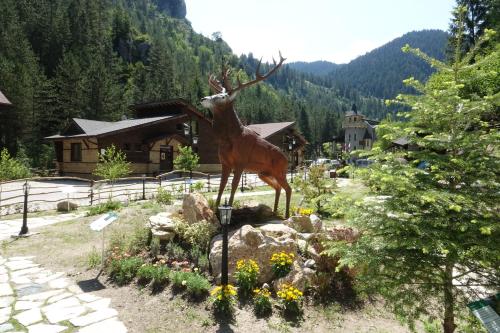 a statue of a deer in a garden at Horlog Castle in Trigrad