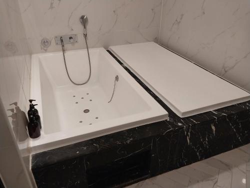 a white bathroom with a shower and a sink at Brown Dot Hotel Busan Station in Busan