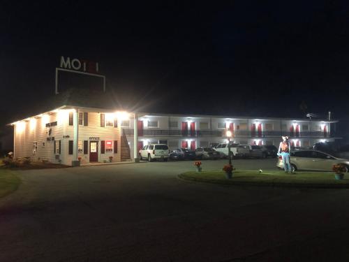 a motel with cars parked in front of it at night at Motel Boutique by Wolf Inn in Milan