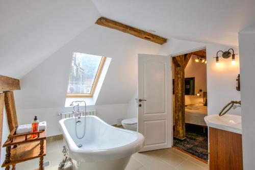 a bathroom with a white tub and a sink at Residence Central Annapolis in Braşov