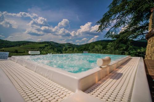 a swimming pool with a pool table and chairs at Capannelle Wine Resort in Gaiole in Chianti