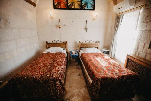 Postel nebo postele na pokoji v ubytování Artium Cave Hotel